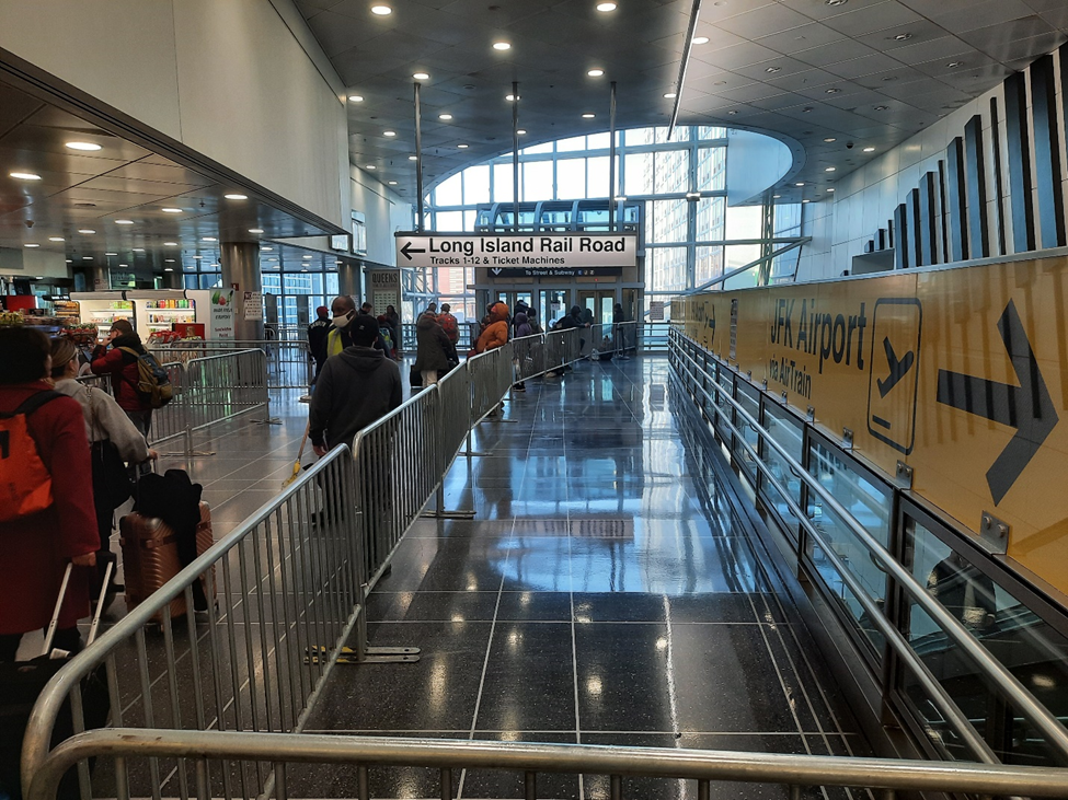 The once glistening AirTrain corridor is now truncated with barriers that treat passengers like cattle. Photo: Liam Jeffries