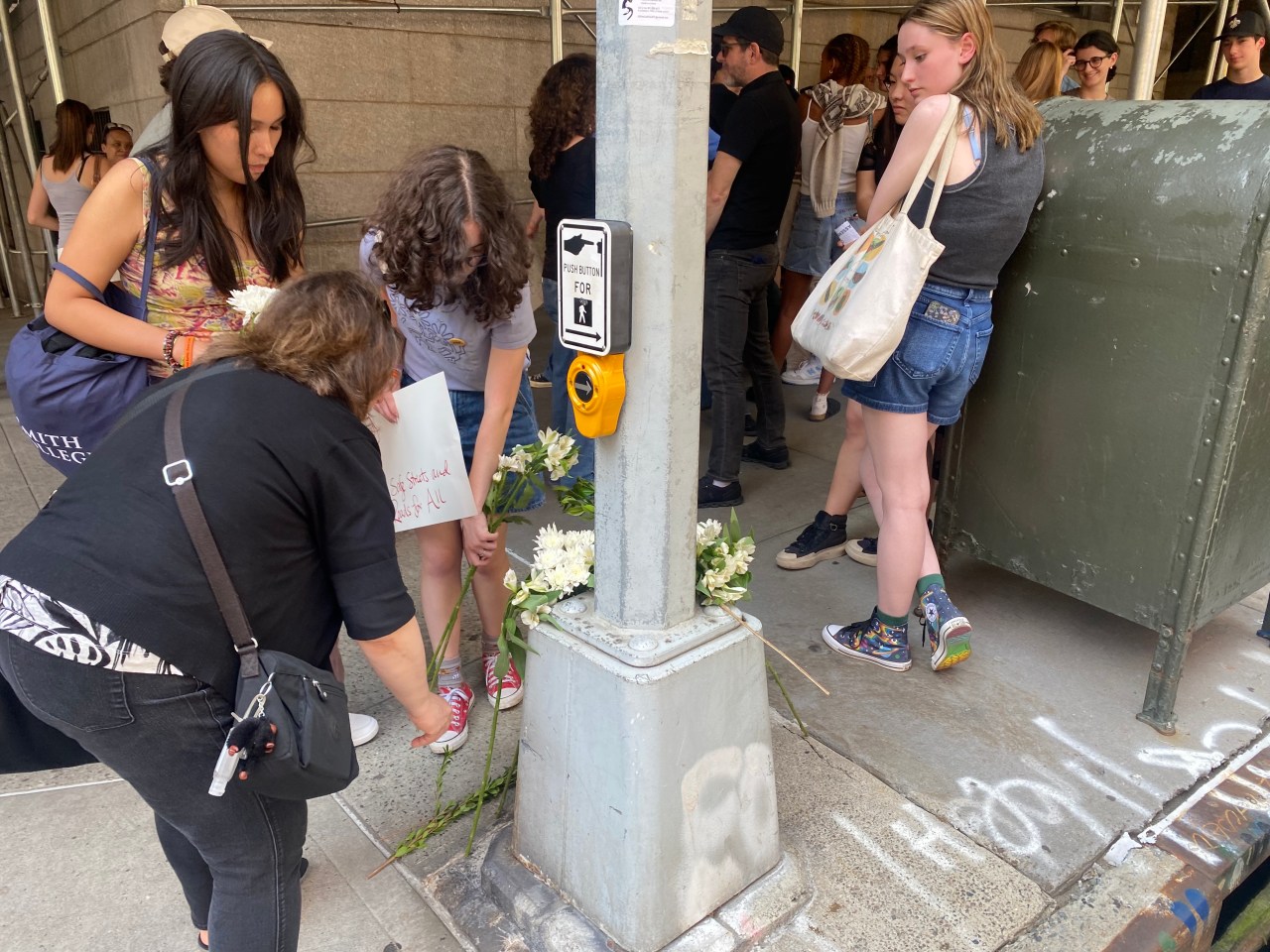 Classmates and friends lay flowers at the intersection where cooper was killed. Photo: Kevin Duggan