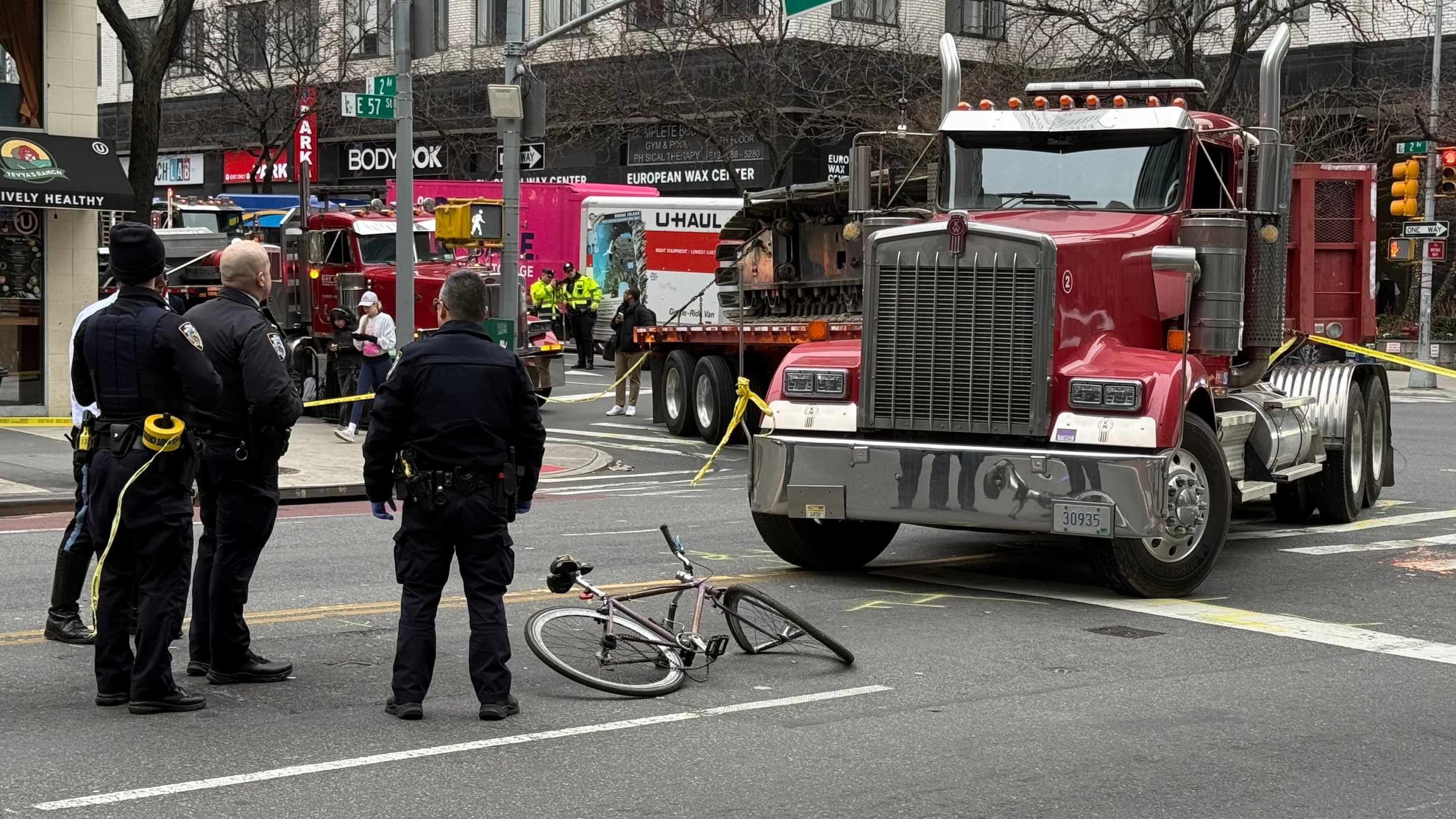 Photo of truck that injured cyclist is parked next to mangled bicycle of victim